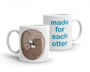 Two white Made For Each Otter mugs: one with two curled-up otters, one with "made for each otter"