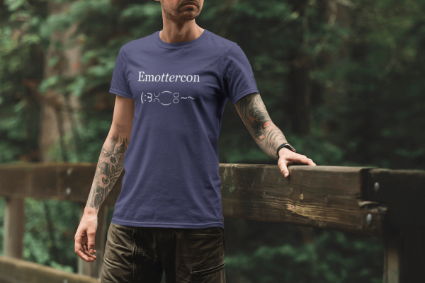 Man wearing Emottercon Unisex T-shirt in Heather Midnight Navy in the woods.
