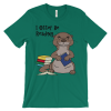 Kelly green I Otter Be Reading T-shirt: a cartoon otter hugging a book by a stack of books