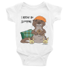 I Otter Be Sleeping Baby Bodysuit-white-front | Otter Things White I Otter Be Sleeping baby bodysuit: a sleepy otter in a nightcap and bunny slippers beside a plaid pillow