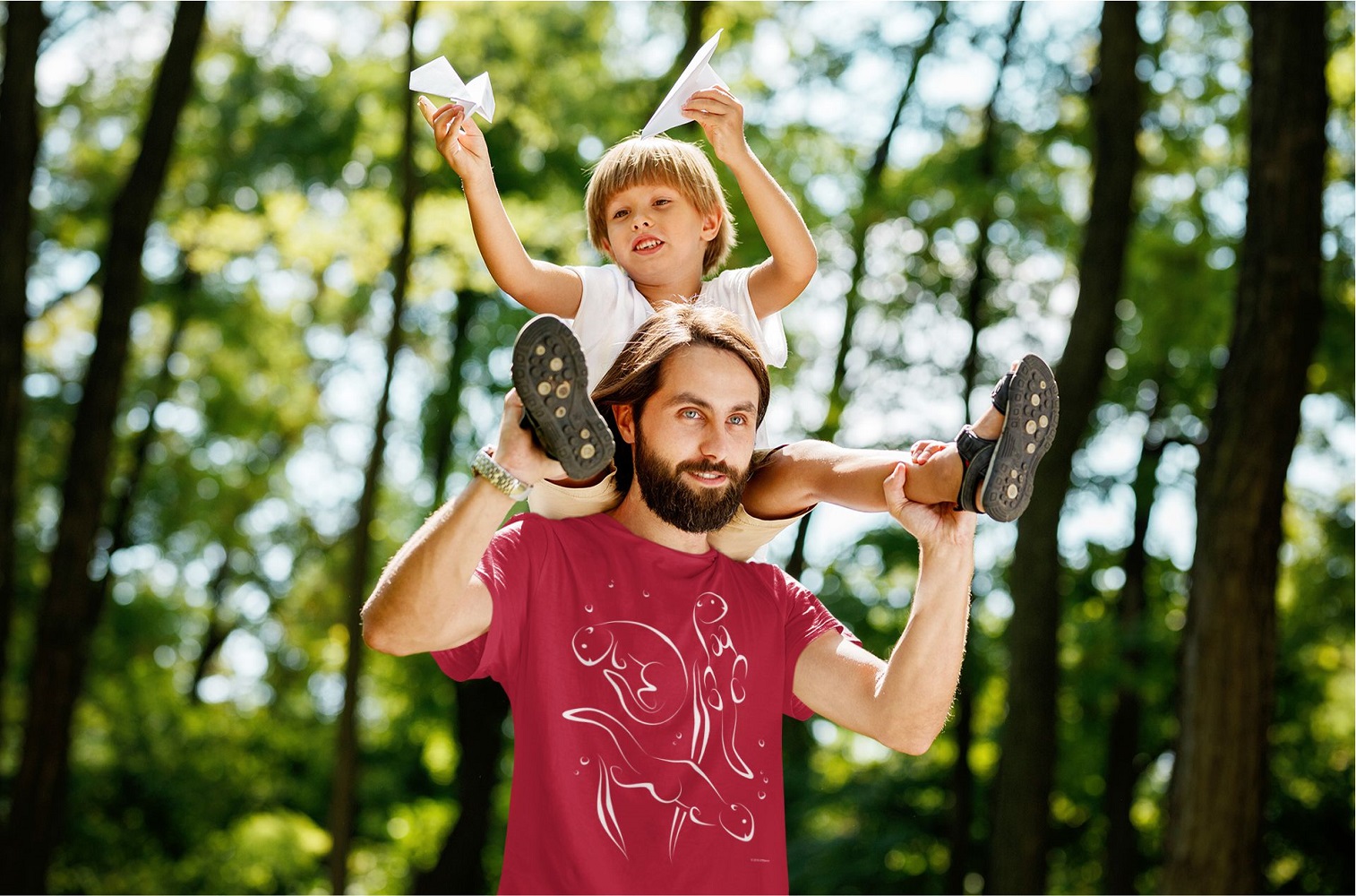 Otters Swimming Unisex Short-sleeve T-shirt-red-lifestyle | Otter Things Person in a red Otters Swimming T-shirt carrying a child on their shoulders in the woods