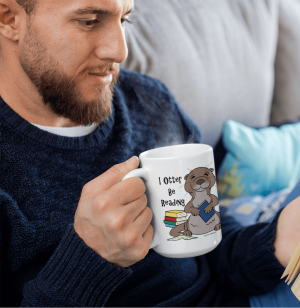 Bearded person on a couch holding the I Otter Be Reading mug