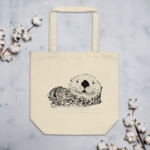 Pen & Ink Sea Otter Head eco tote laid flat on marble with cotton stems