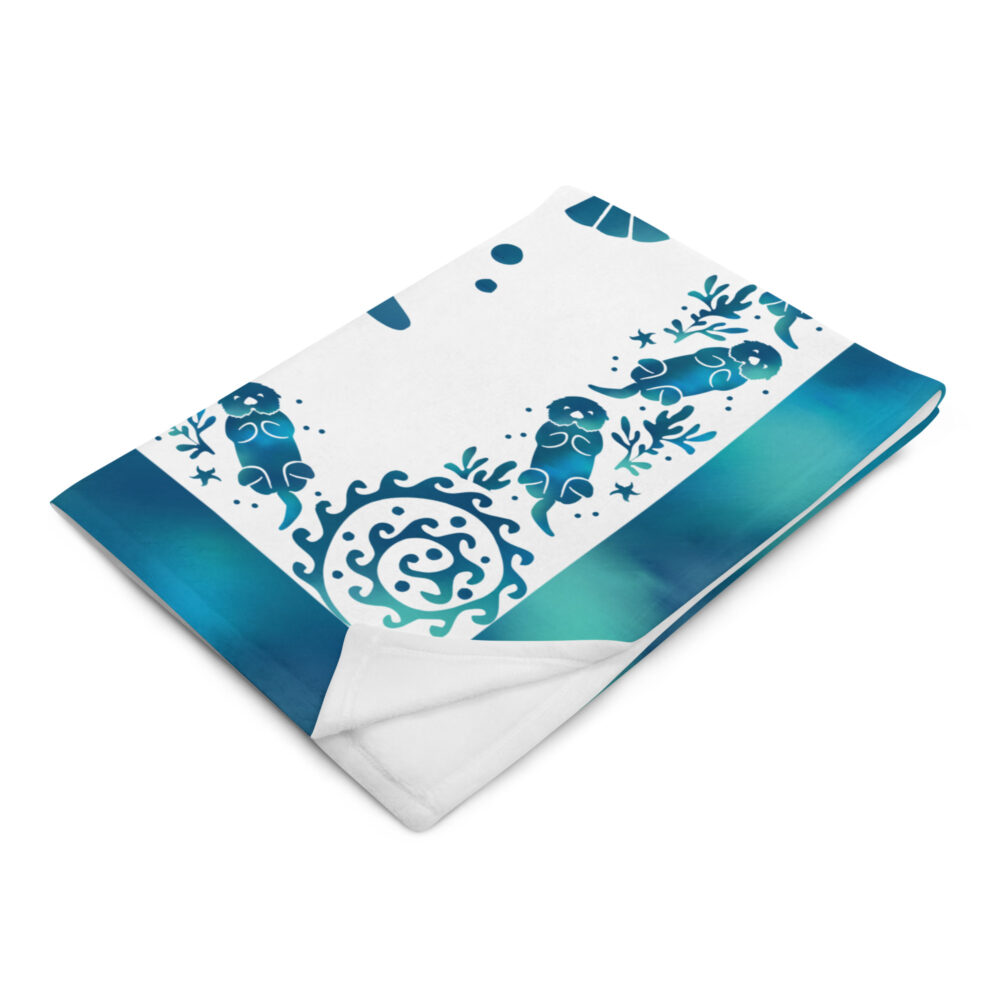 Sea Otter Tie-dye Throw Blanket-50x60-left-front | Otter Things Folded Sea Otter Tie-Dye throw blanket showing its blue shell border and otters