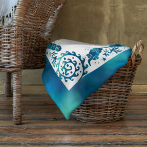 Sea Otter Tie-dye Throw Blanket-60x80-lifestyle | Otter Things Sea Otter Tie-Dye throw blanket folded in a wicker basket on a wooden floor