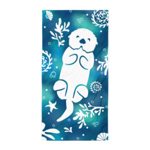 The Sea-Otter-Tie-Dye-Beach-Towel showcases a white sea otter silhouette on its back, surrounded by seaweed, shells, starfish, and swirls atop a blue-green ombre background.
