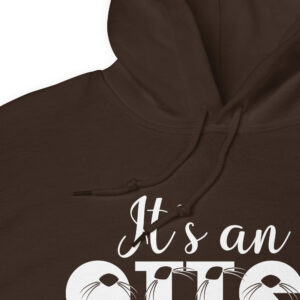 Unisex-heavy-blend-hoodie-dark-chocolate-product-details-6abac5d641ddd | Otter Things A close-up of a brown hoodie with “It’s an” written in white script and part of another word showing below, featuring printed whiskers as part of the design.